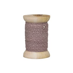 Lace ribbon on wooden spool antique rose